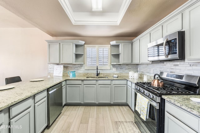 400 Rio Fango, El Paso, TX 79932 - kitchen with a tray ceiling, open shelves, a sink, stainless steel appliances, and backsplash