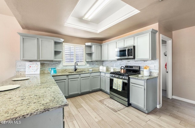 400 Rio Fango, El Paso, TX 79932 - kitchen with tasteful backsplash, open shelves, light stone countertops, appliances with stainless steel finishes, and a sink