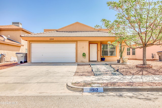 view of front of home featuring a tile roof, stucco siding, a garage, and concrete driveway