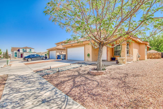view of front of house featuring an attached garage, driveway, and stucco siding