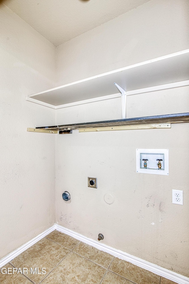 laundry area with baseboards, hookup for a gas dryer, laundry area, hookup for an electric dryer, and tile patterned flooring