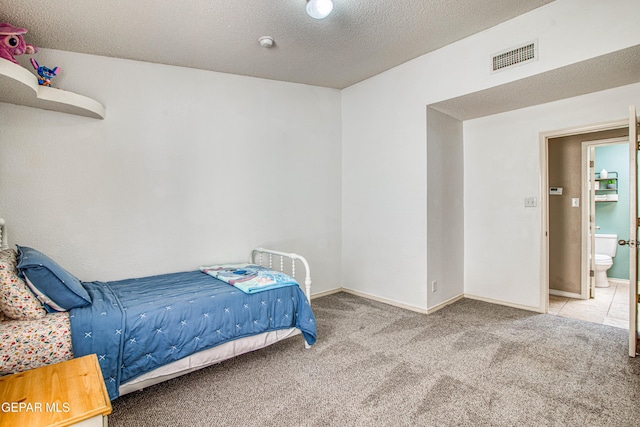 bedroom with visible vents, baseboards, carpet, and a textured ceiling