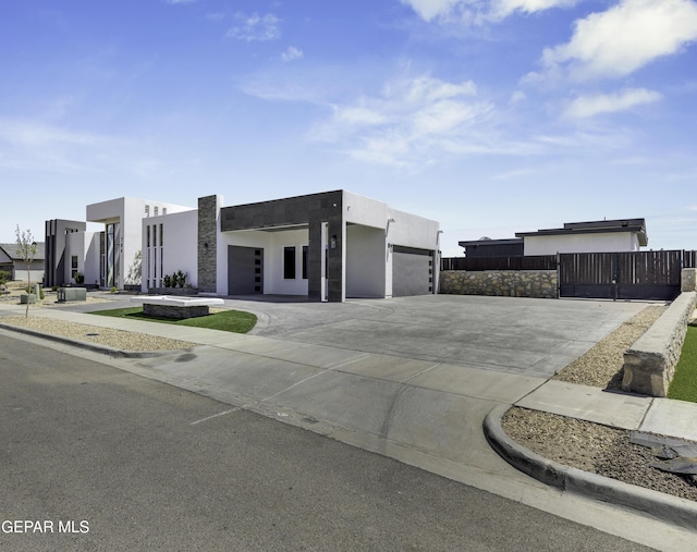 784 Brunswick Pl, Horizon City, TX 79928 - contemporary house with an attached garage, driveway, stucco siding, and fence