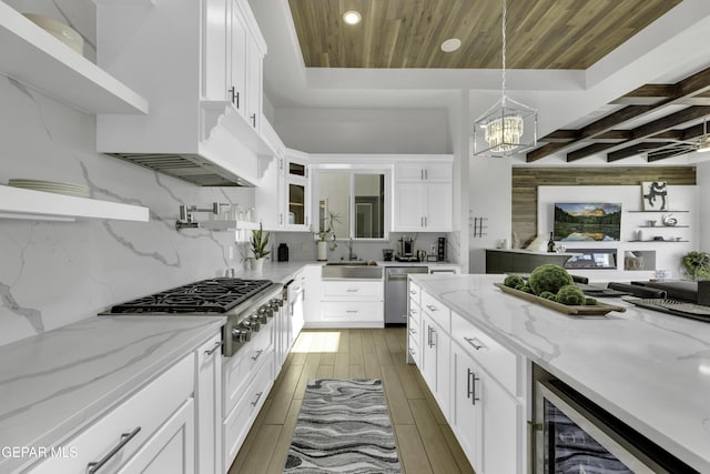 784 Brunswick Pl, Horizon City, TX 79928 - kitchen featuring a chandelier, appliances with stainless steel finishes, a sink, beverage cooler, and backsplash
