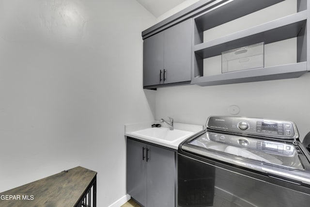 784 Brunswick Pl, Horizon City, TX 79928 - laundry area featuring cabinet space, baseboards, washer / dryer, and a sink
