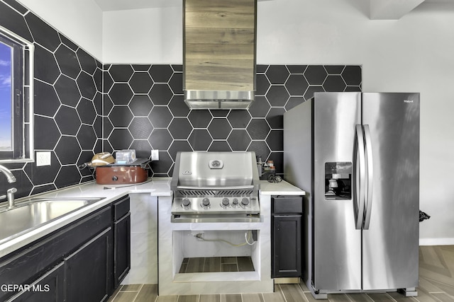 784 Brunswick Pl, Horizon City, TX 79928 - kitchen with stainless steel fridge, a sink, light countertops, dark cabinets, and decorative backsplash