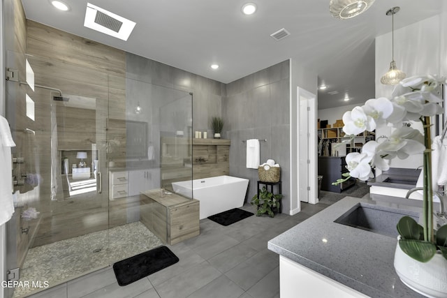 784 Brunswick Pl, Horizon City, TX 79928 - bathroom with visible vents, tile walls, and a stall shower