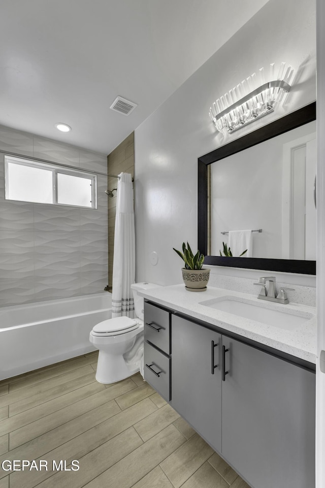 784 Brunswick Pl, Horizon City, TX 79928 - bathroom with vanity, visible vents, toilet, wood finished floors, and shower / tub combo with curtain