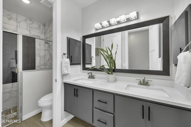 784 Brunswick Pl, Horizon City, TX 79928 - full bath with toilet, double vanity, a sink, and a marble finish shower