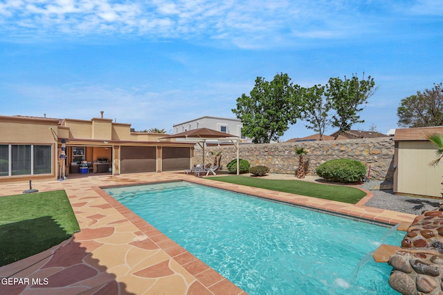 view of swimming pool featuring a fenced in pool, a patio, a fenced backyard, and an outdoor structure