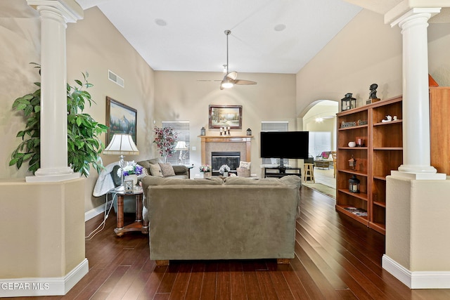 living area with visible vents, dark wood finished floors, decorative columns, and a ceiling fan