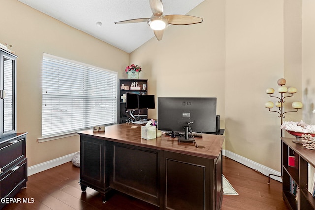 office area with baseboards, dark wood-type flooring, vaulted ceiling, and a ceiling fan
