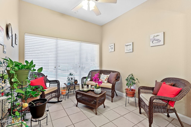 sitting room featuring light tile patterned floors, baseboards, and a ceiling fan