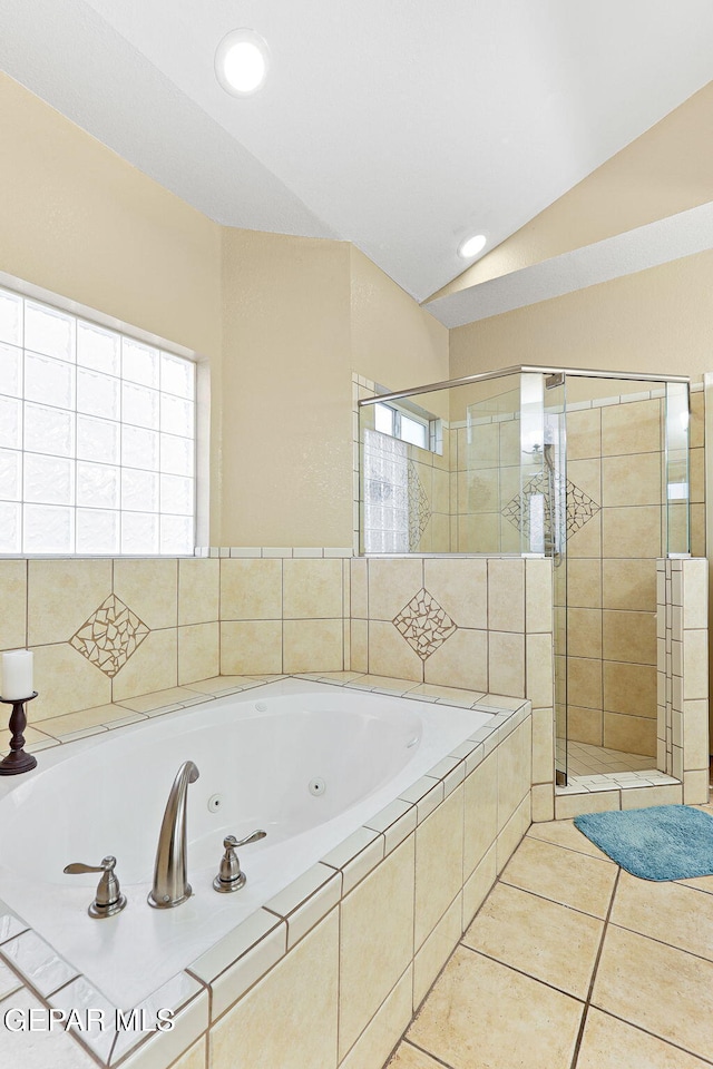 full bathroom with a whirlpool tub, tile patterned floors, a shower stall, and vaulted ceiling