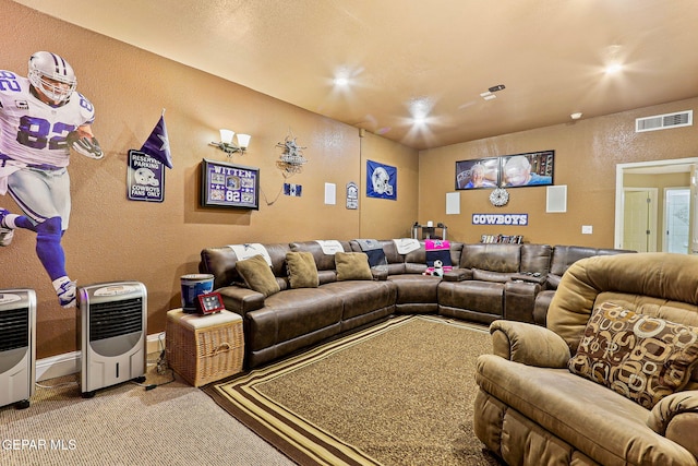 living room featuring a textured wall, carpet, visible vents, and heating unit