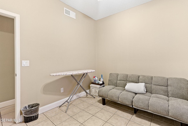 interior space with light tile patterned floors, visible vents, and baseboards