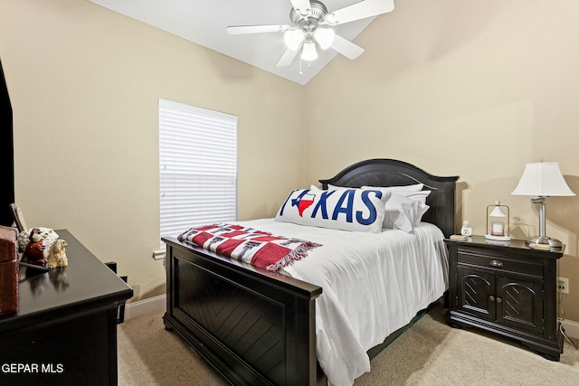bedroom featuring light carpet, ceiling fan, baseboards, and vaulted ceiling