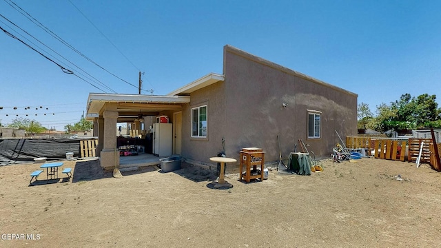 view of home's exterior featuring a patio area, stucco siding, and fence