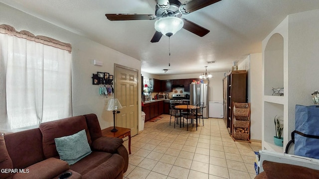 living area featuring light tile patterned flooring, a ceiling fan, and visible vents