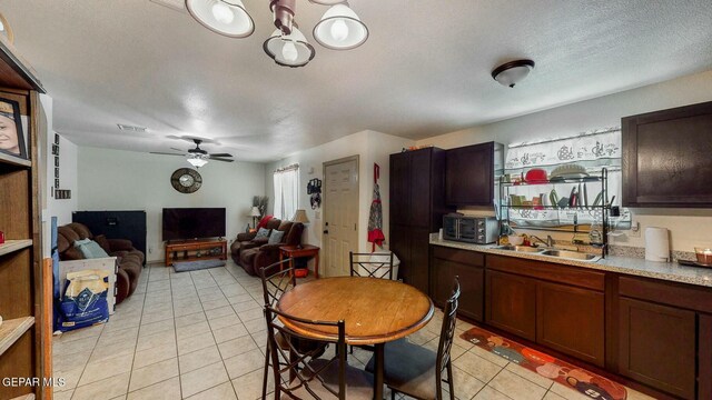 dining room with visible vents, ceiling fan, light tile patterned flooring, and a textured ceiling