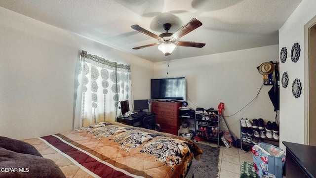 tiled bedroom featuring ceiling fan and a textured ceiling