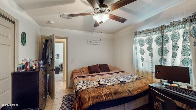 bedroom with light tile patterned floors, ceiling fan, and visible vents