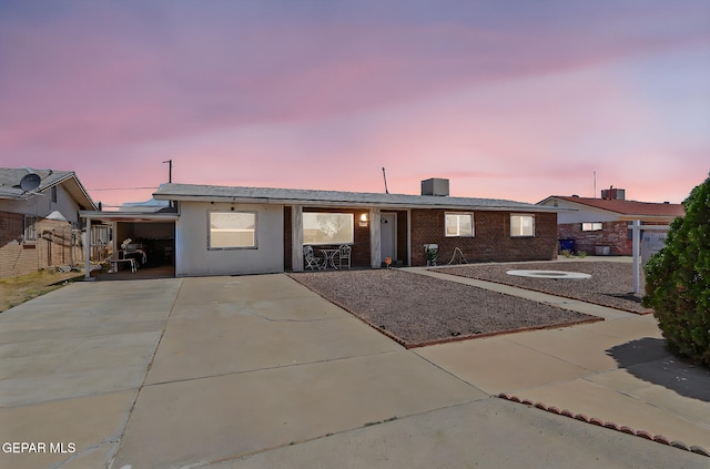 single story home featuring brick siding and driveway