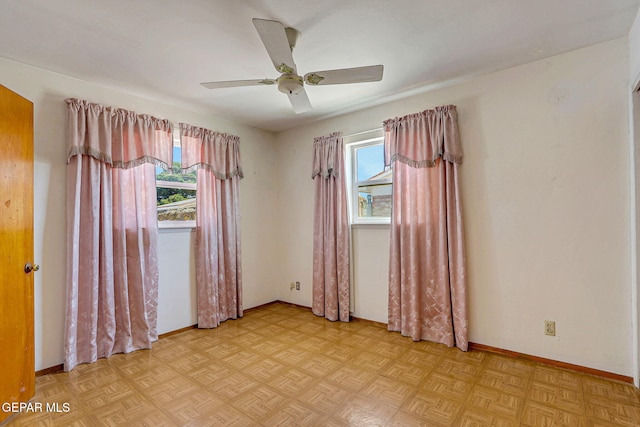 unfurnished room featuring baseboards and a ceiling fan