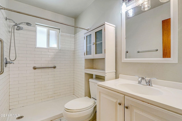 bathroom with vanity, a stall shower, and toilet