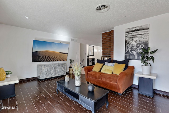 3705 Roslyn Dr, Horizon City, TX 79928 - living area with baseboards, wood tiled floor, visible vents, and a textured ceiling