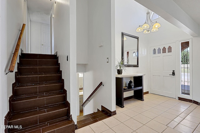 3705 Roslyn Dr, Horizon City, TX 79928 - foyer entrance featuring a towering ceiling, stairway, an inviting chandelier, light tile patterned floors, and baseboards