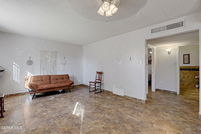3705 Roslyn Dr, Horizon City, TX 79928 - sitting room featuring a textured ceiling, visible vents, baseboards, and a ceiling fan