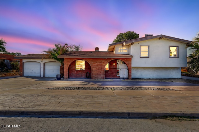 3705 Roslyn Dr, Horizon City, TX 79928 - tri-level home with a chimney, driveway, covered porch, and a garage