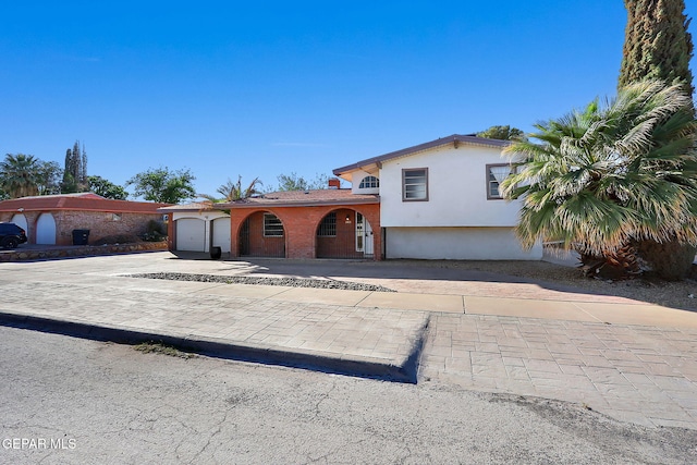 3705 Roslyn Dr, Horizon City, TX 79928 - tri-level home with decorative driveway, stucco siding, and a garage