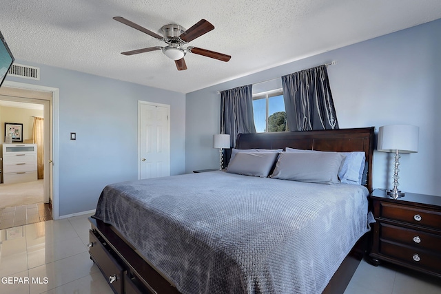 3705 Roslyn Dr, Horizon City, TX 79928 - bedroom featuring light tile patterned flooring, a textured ceiling, and visible vents