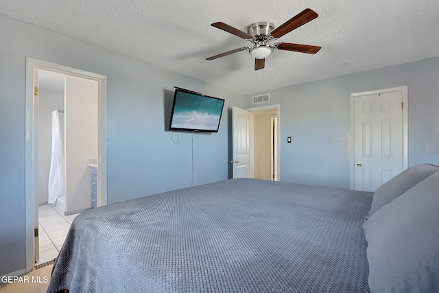 3705 Roslyn Dr, Horizon City, TX 79928 - bedroom featuring ceiling fan, a textured ceiling, light tile patterned floors, and visible vents
