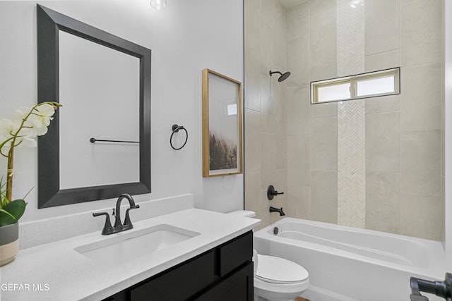 bathroom featuring toilet, bathing tub / shower combination, and vanity