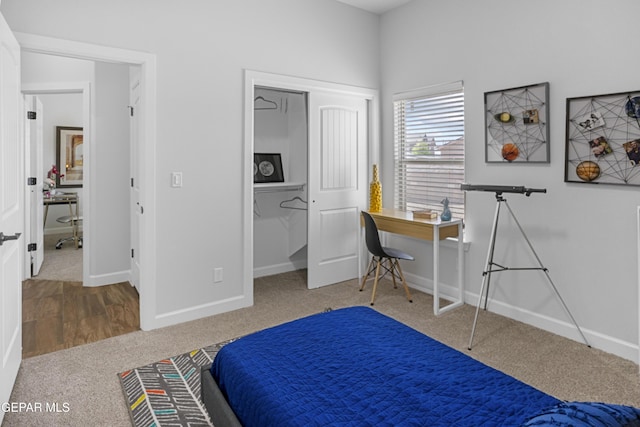 bedroom with a closet, baseboards, and carpet floors