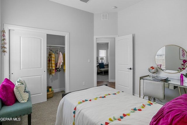 bedroom featuring a closet, baseboards, visible vents, and carpet floors