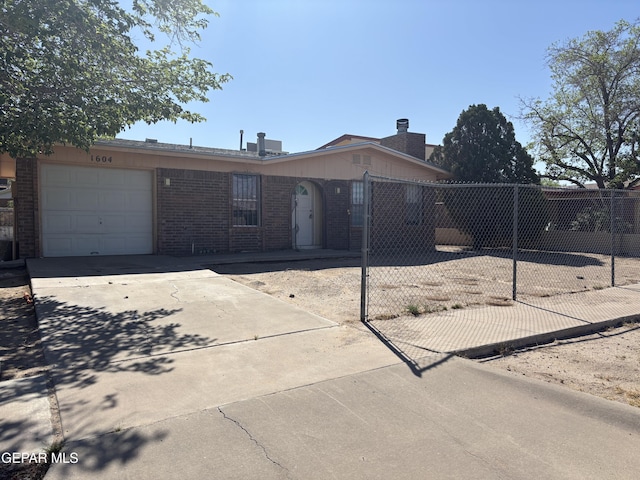1604 Rick Rhodes Dr, El Paso, TX 79936 - ranch-style house with brick siding, driveway, fence, and a garage