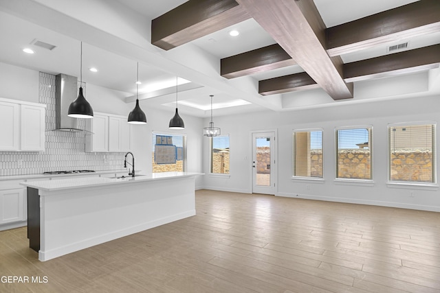 3792 Surmise St, El Paso, TX 79938 - kitchen featuring a sink, wall chimney range hood, tasteful backsplash, light countertops, and white cabinets