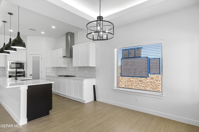 3792 Surmise St, El Paso, TX 79938 - kitchen with wall chimney exhaust hood, stainless steel microwave, a sink, gas cooktop, and tasteful backsplash