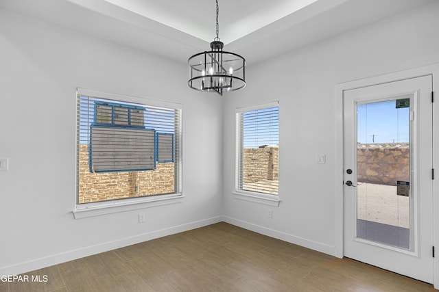 3792 Surmise St, El Paso, TX 79938 - unfurnished dining area featuring plenty of natural light, a chandelier, wood finished floors, and baseboards