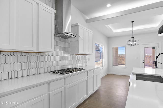 3792 Surmise St, El Paso, TX 79938 - kitchen featuring wall chimney range hood, stainless steel gas stovetop, a sink, a raised ceiling, and decorative backsplash