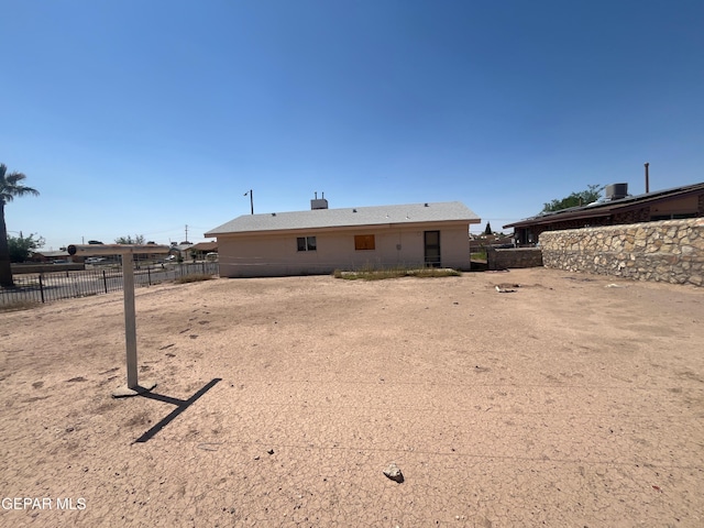 back of house with fence