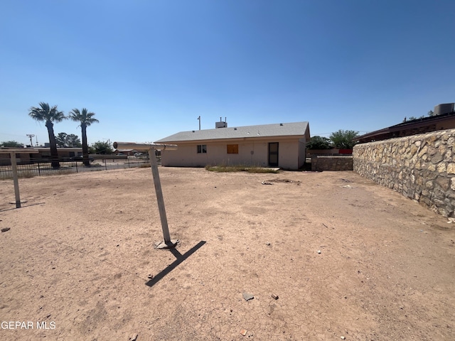 rear view of property with fence