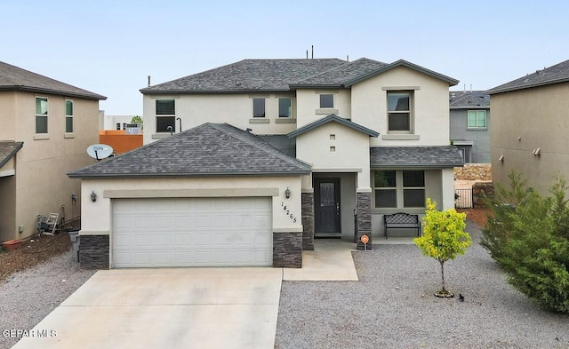 view of front of property with concrete driveway, stone siding, roof with shingles, stucco siding, and a garage