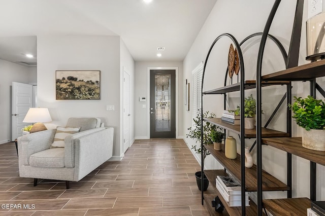 foyer with recessed lighting, baseboards, and wood finish floors
