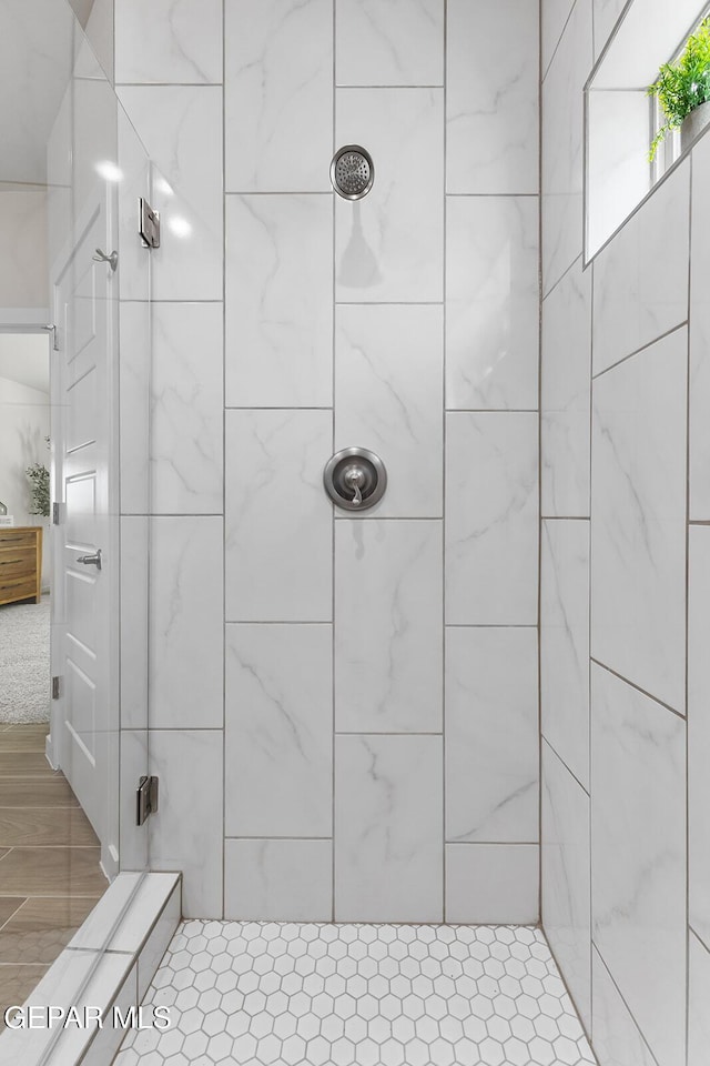 bathroom with a tile shower