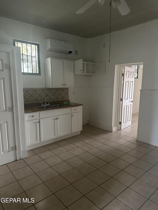 3506 Pera Ave Unit A & B, El Paso, TX 79905 - kitchen featuring a wall mounted air conditioner, a sink, dark countertops, ceiling fan, and backsplash
